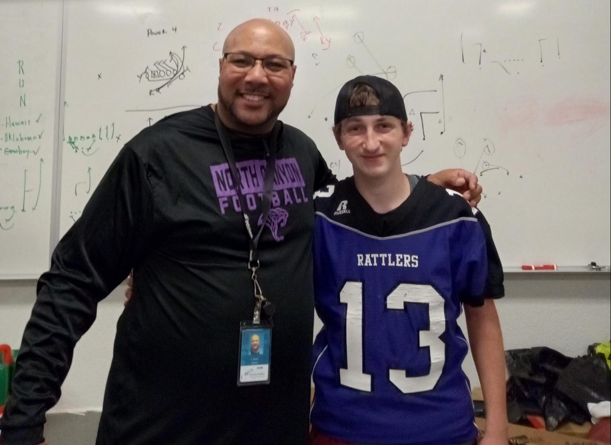 Coach Collins with JV Rattler football player.