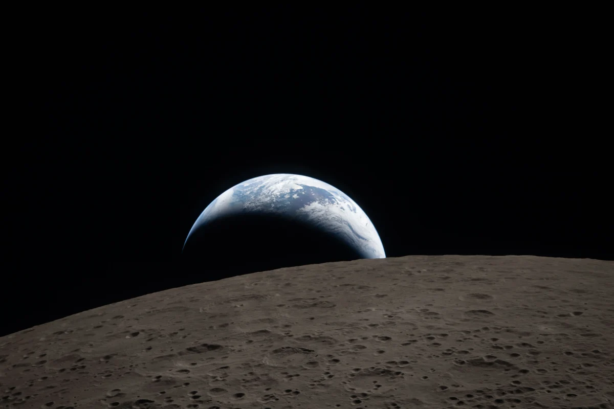 Earthset, capture by Christina Koch during Artemis II's lunar flyby echoing back to Apollo 8's Earthrise photo.